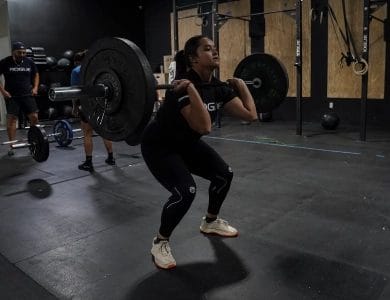 Ayleen Tamez catching a barbell in a front squat at Deepwater CrossFit